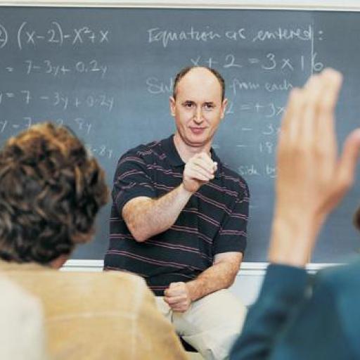 A picture of a teacher in front of a group of students.