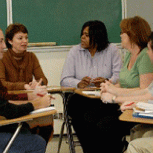 A teacher in discussion with a group of students.